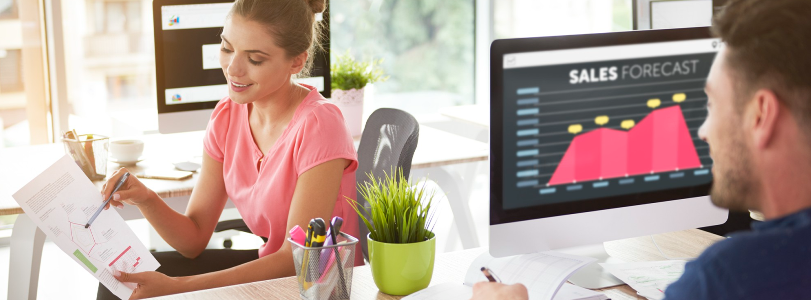 a man and woman discussing a software development outsourcing project